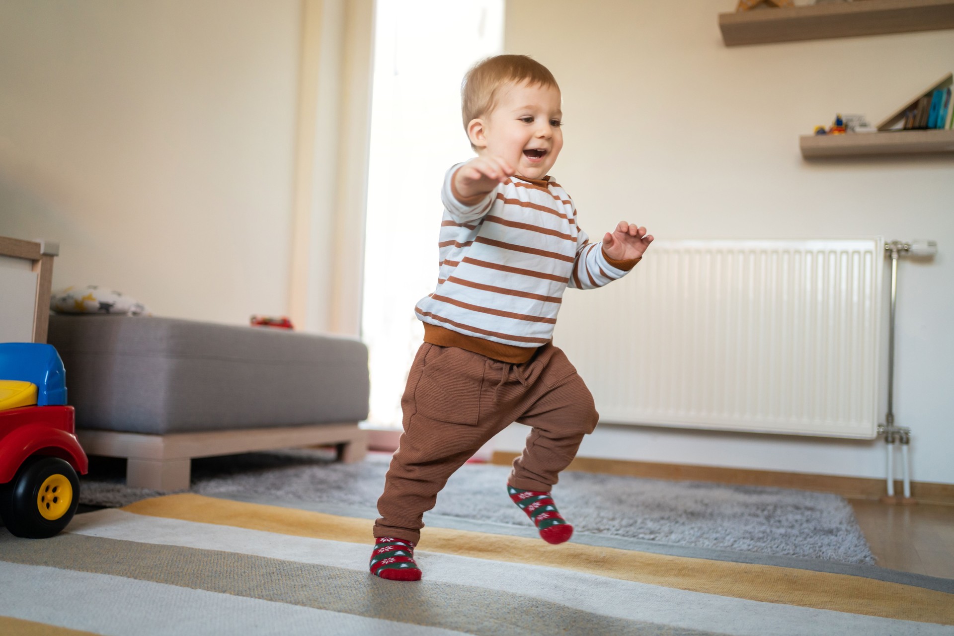 Smiling little boy walking around the house